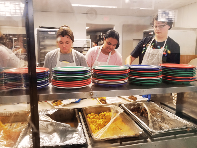 A&SRC students prepare and serve food during a community service activity.