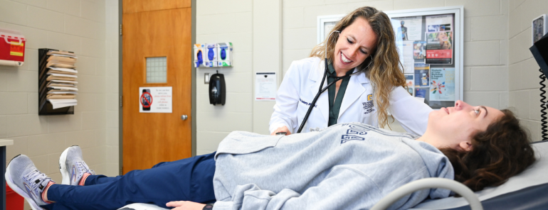 A student is examined at University Health Services during an office visit. 