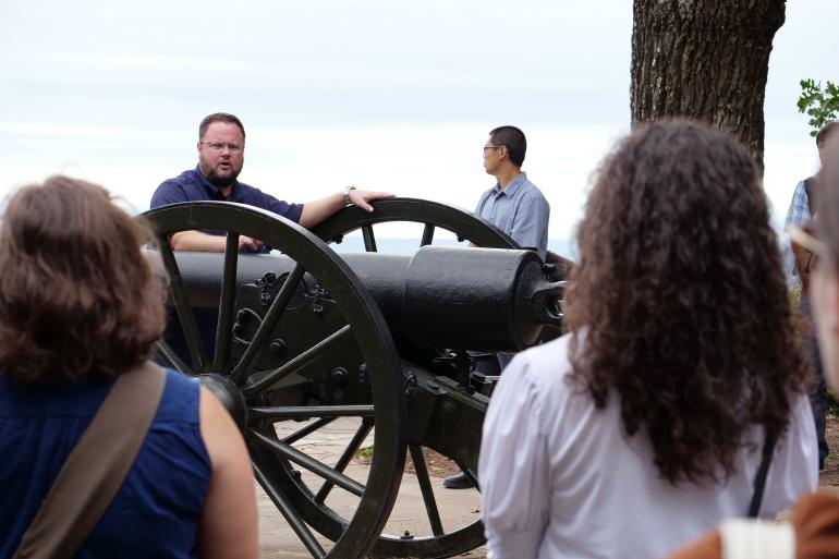 faculty talking by a cannon