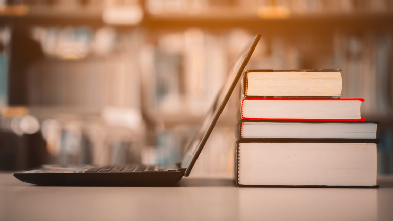 A laptop and Book on a library table