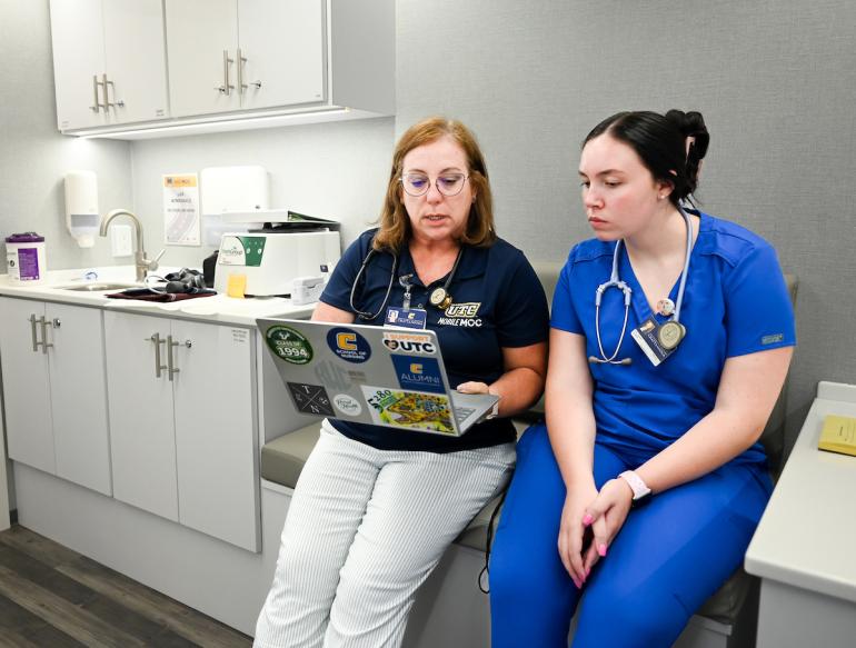 Dr. Wick teaching a student inside the mobile clinic