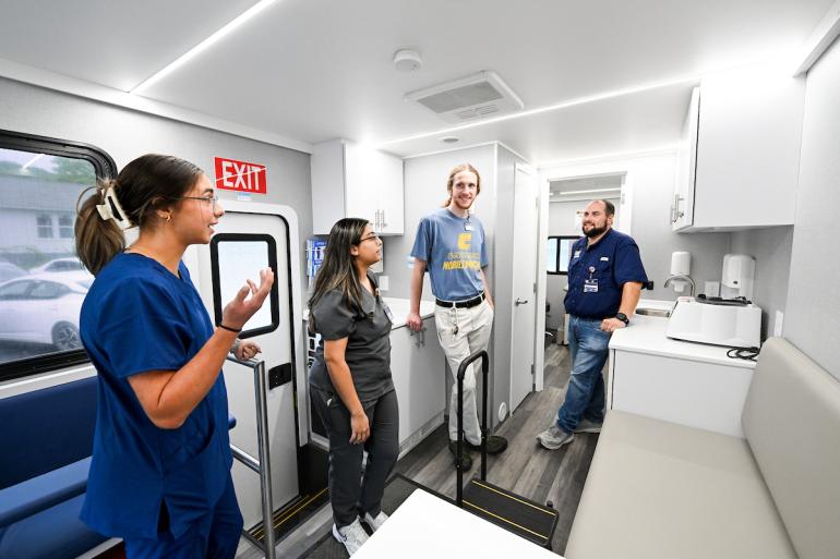 MobileMOC staff showing students the mobile clinic