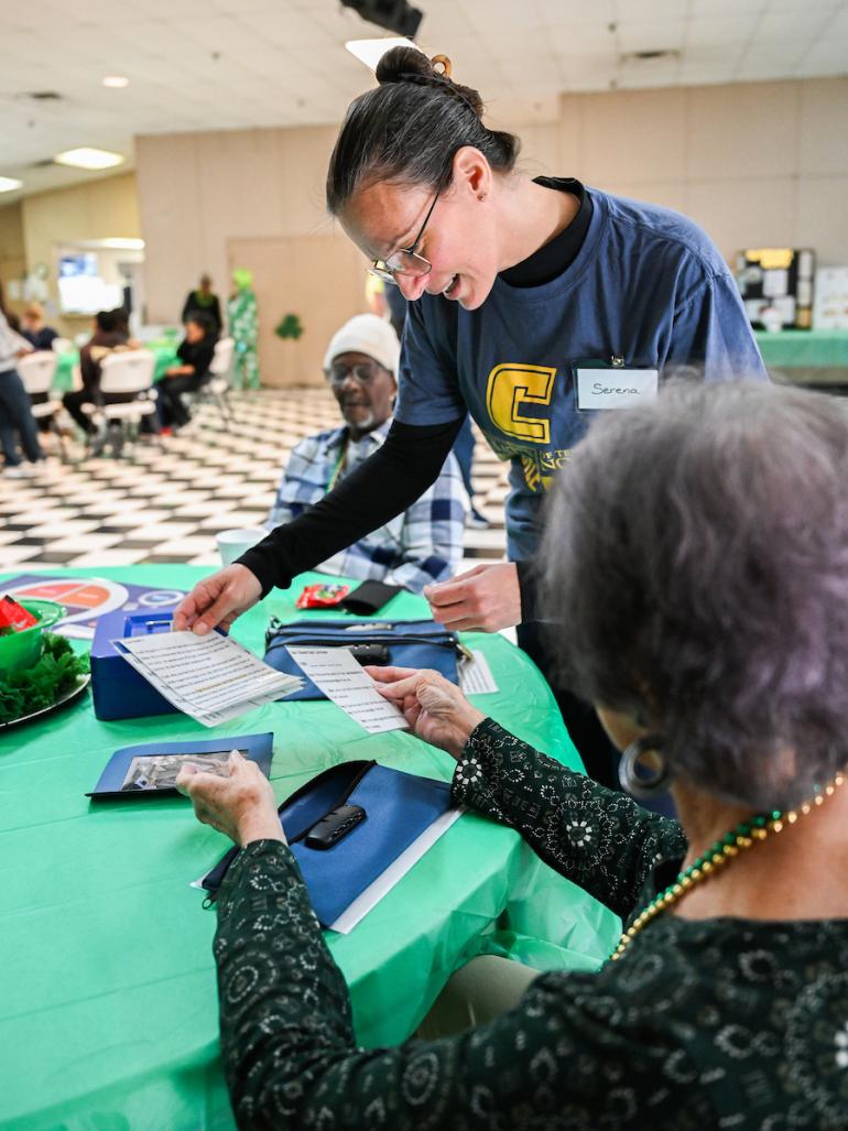 Master in Public Health student teaching older adults in the Bradley-Cleveland Senior Center