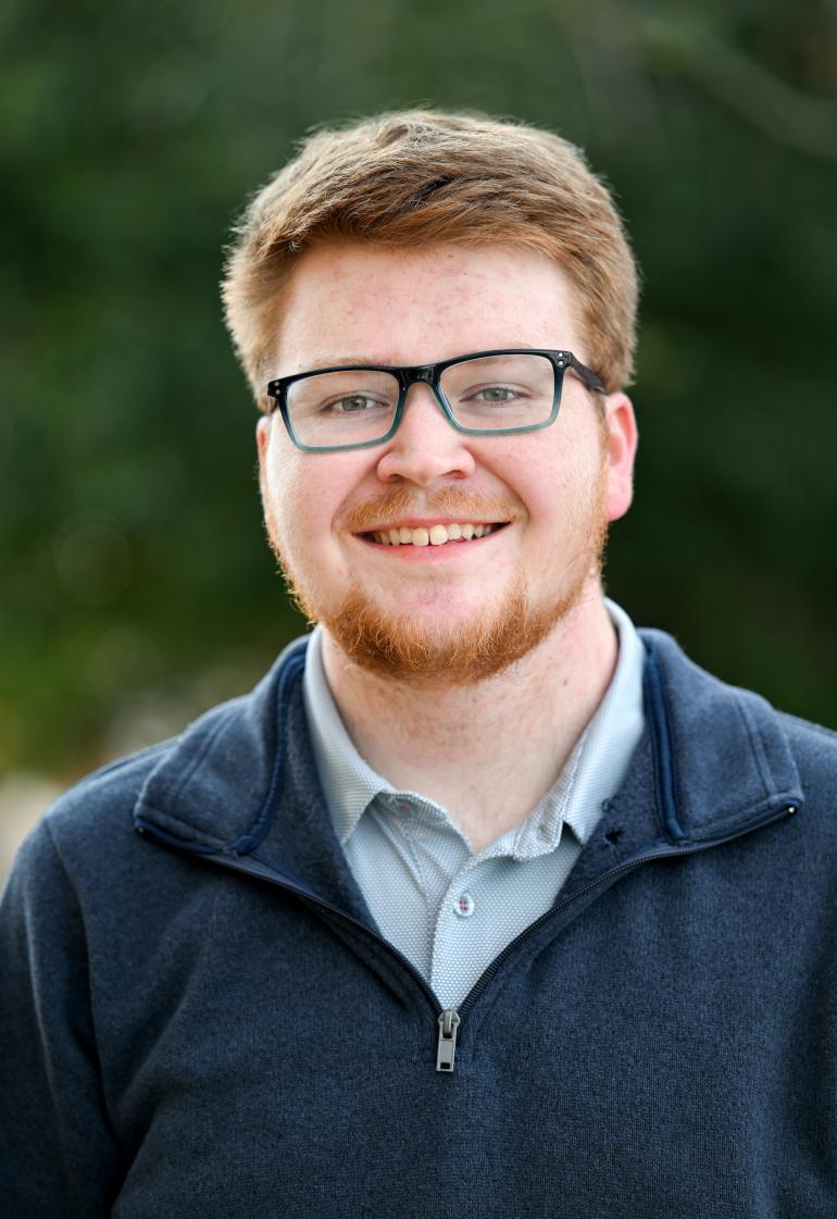 Professional headshot of John.