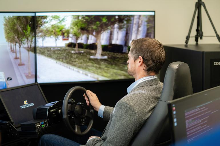 Chattanooga Connect 2025 participant using a driving similator.