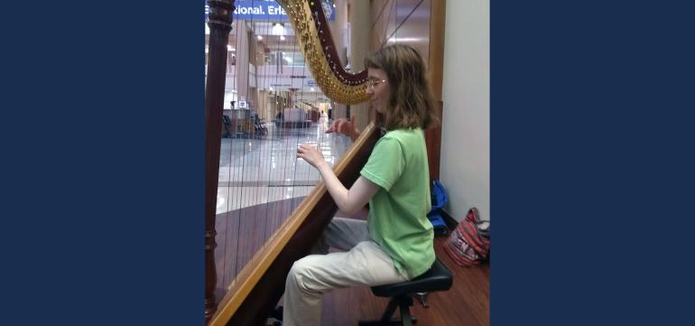 Margaret Coulter plays the harp at Erlanger