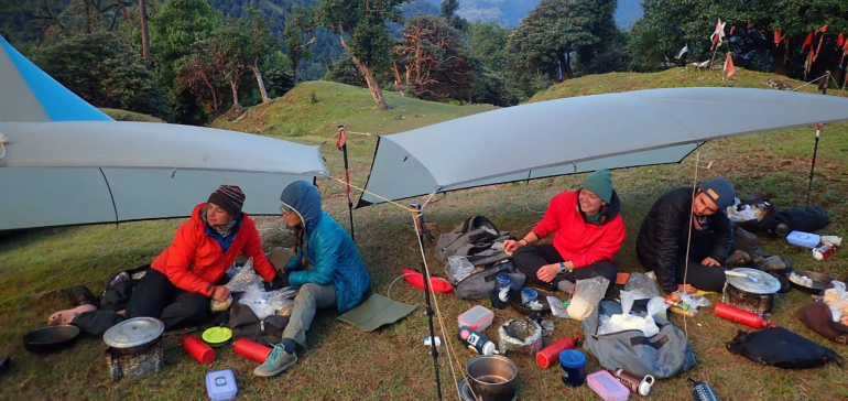 Students camping and eating during a mountain trek