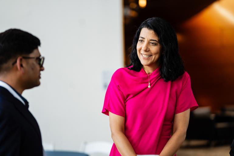 A woman in conversation smiling