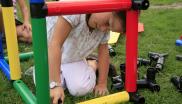 Girl working on building her own EMU with colorful pipes