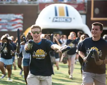 Student running on football field