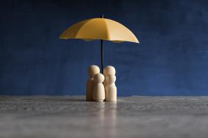 Protection from Harm Wooden dolls under utc gold umbrella