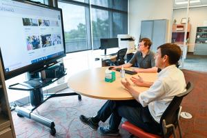UTC disability services UTC staff on a virtual call in a conference room