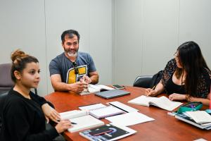 UTC tutoring UTC students sitting around a desk with open notebooks