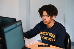 UTC Online Programs and Degrees UTC student looking at a computer