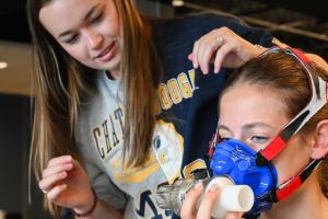 HHP Sports Lab girl getting fitted for a mask HHP Sports Lab girl getting fitted for a mask