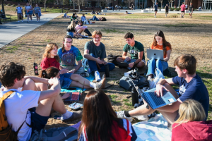 Students Working Outside Students sitting outside in a circle having a discussion