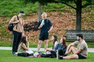Students Outdoors Several students congregate on the green for study and social interaction.