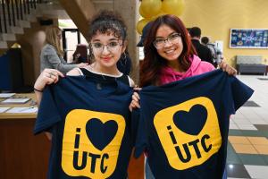 I Love UTC Week two students holding shirts that read "I heart UTC"