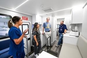 MobileMOC staff showing students the mobile clinic