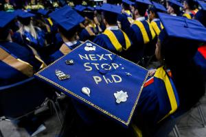 UTC graduation cap with a message that reads "Next Stop PhD"
