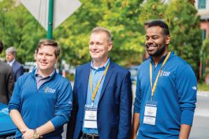 Three men standing wearing UTC CUIP pullovers