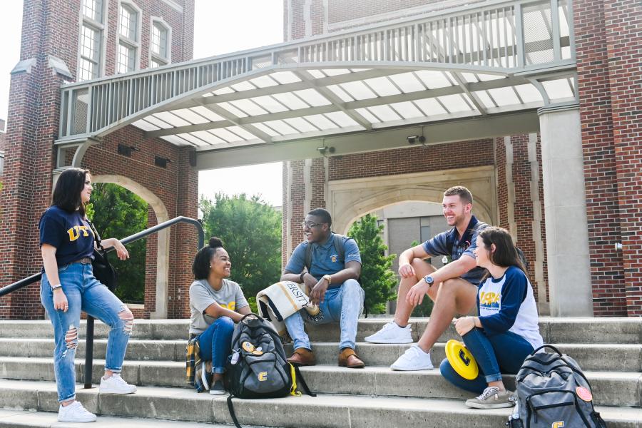 Orientation leaders sitting on college campus steps