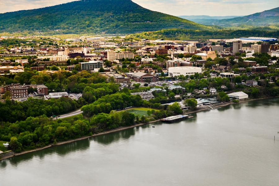 Aerial photo of campus surrounded by the mountains and river