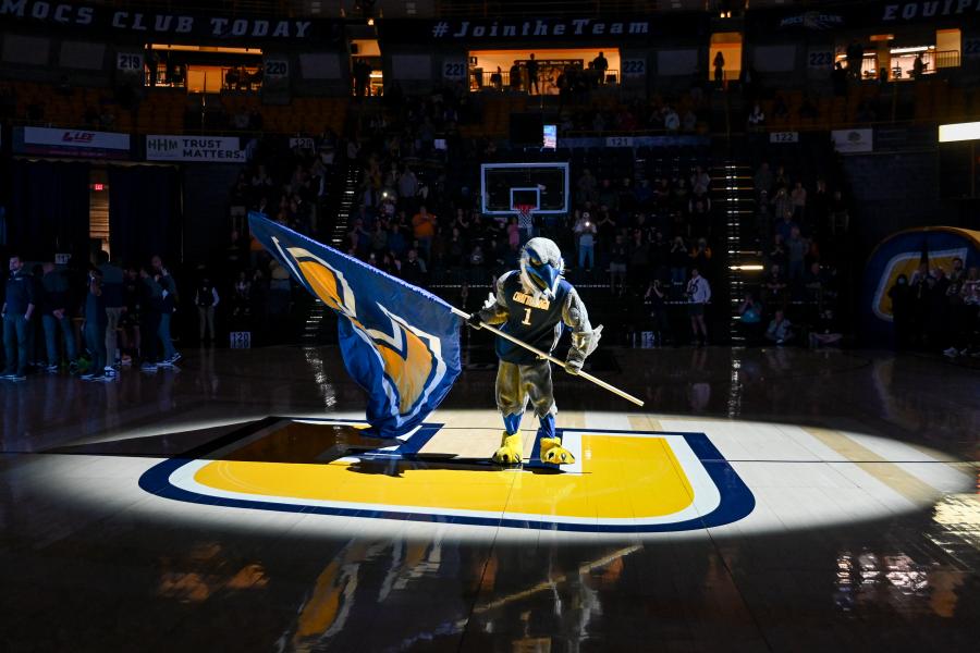 Scrappy Basket Ball Game Scrappy holding a power C flag