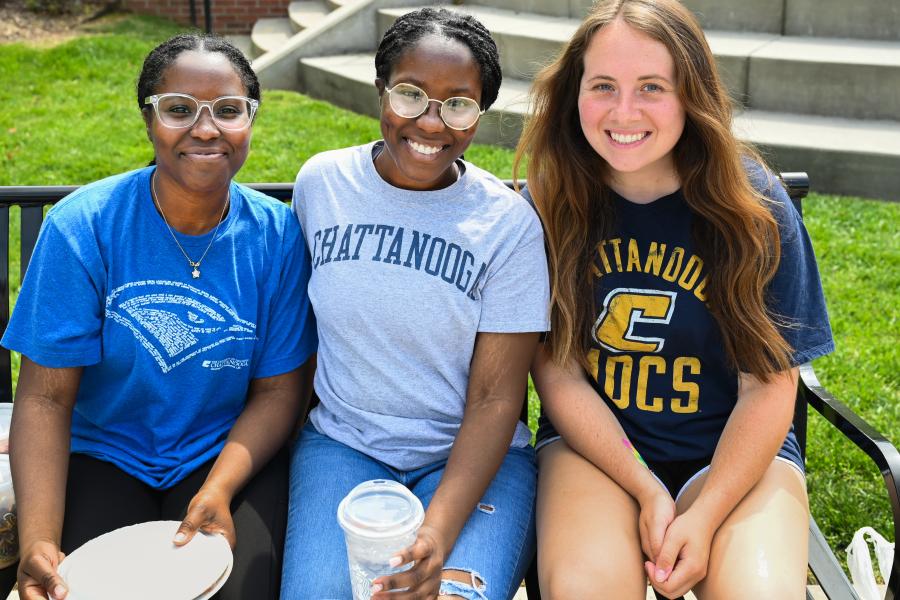 three UTC female students on campus in the sun