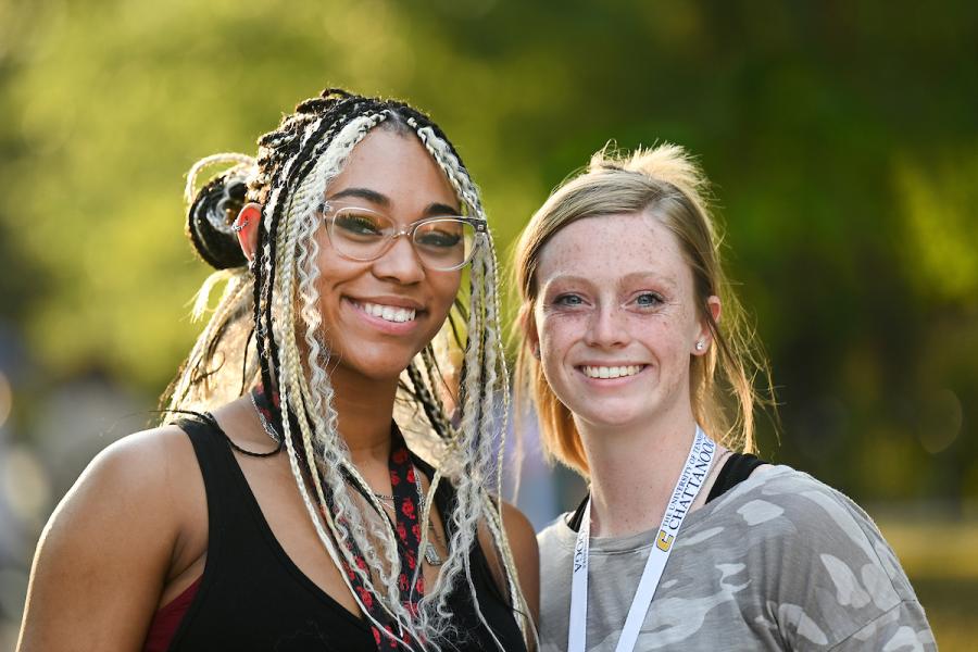 UTC female students in front of a blurred background
