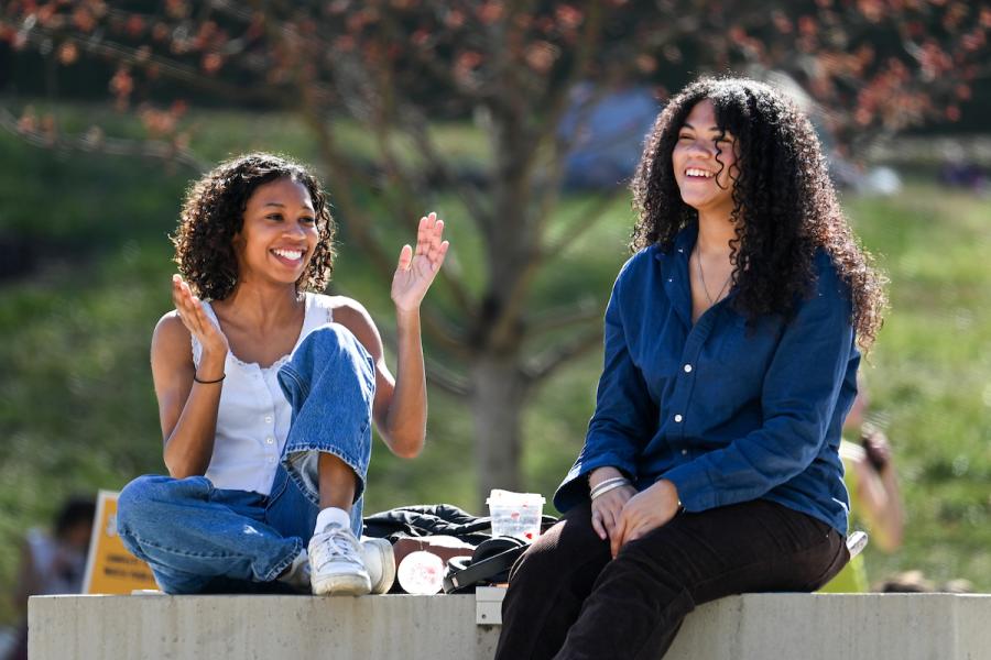 UTC Admissions Two UTC students sitting outside on Chamberlain field