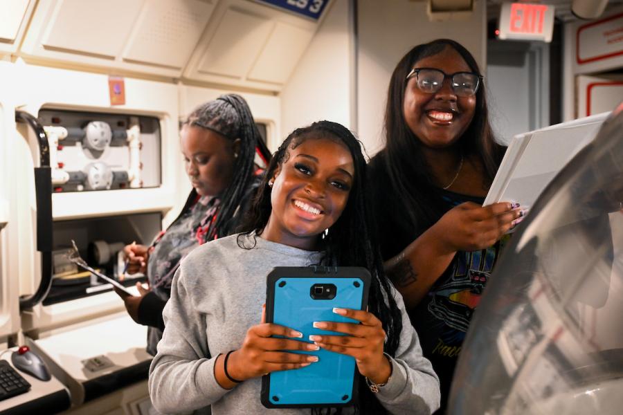 UTC students working on tablets in a science center