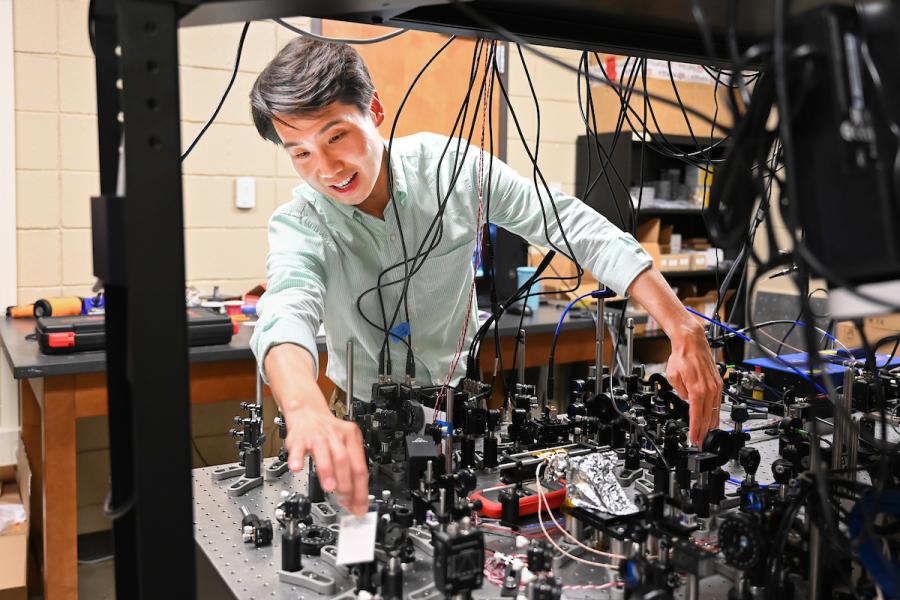 UTC Quantum camp UTC quantum student looking at lab equipment