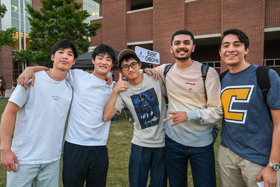 UTC Transfer Week UTC students standing outside at the back to school cookout