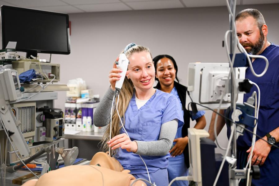 Two UTC students practicing air way techniques on a test mannequin 