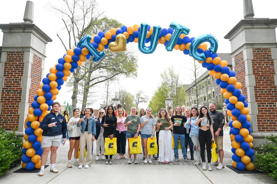 Students under balloon arch at UTC. 