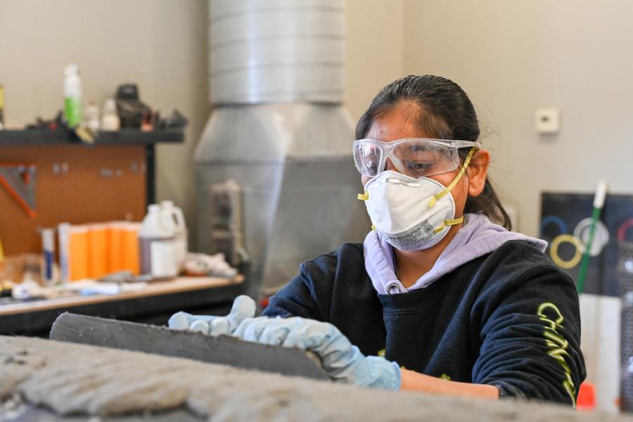 Students work on the concrete canoe Saturday, Feb. 4, 2023 in the ASCE building