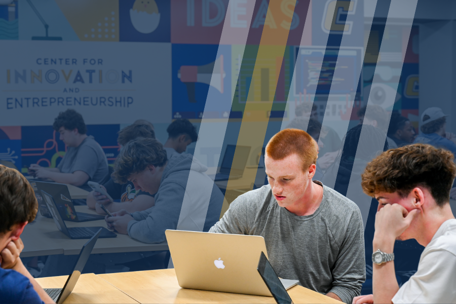 An entrepreneurship student at RCOB is working on a laptop in the Center for Innovation and Entrepreneurship.