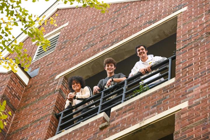 Male students looking down fromt the balcony. Male students looking down fromt the balcony.