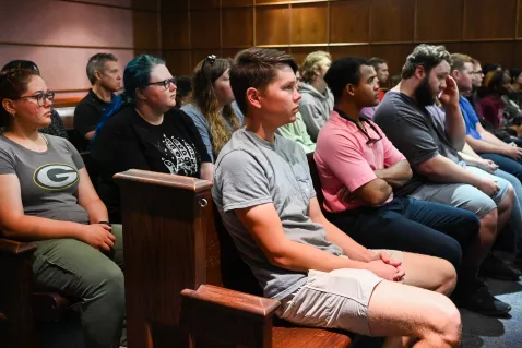 People sitting in court pews