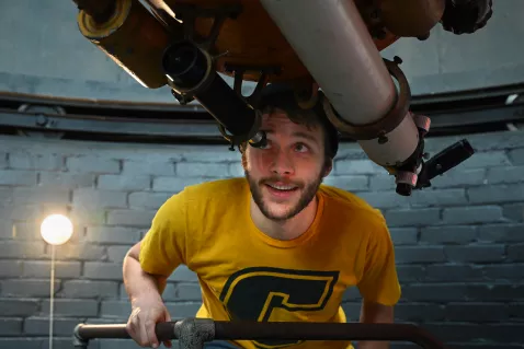 UTC Physics Student looking through the observatory telescope
