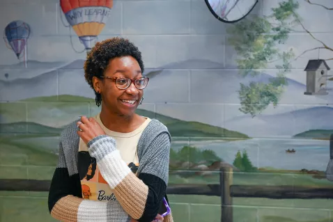 UTC Counselor Education student in front of a mural