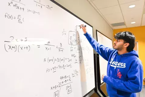 UTC Mathematics male student in front of a white board